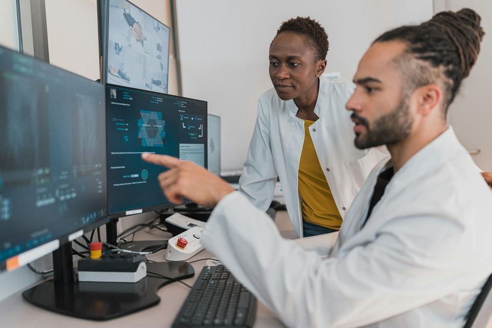 Two doctors reviewing patient information together during a clinical meeting